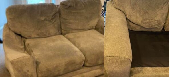 A couch with two pillows and one is in the background